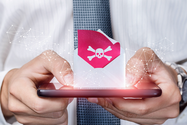 A man holding a phone with a danger icon 