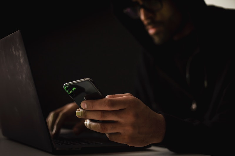 A hacker using his mobile phone