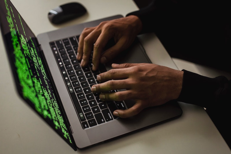 A hacker typing on his laptop 
