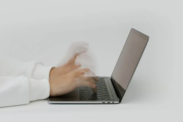 Someone typing very quick on a computer.