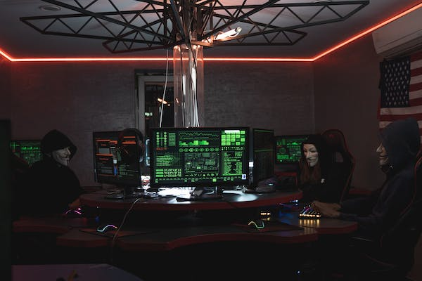 Hackers around a desk 